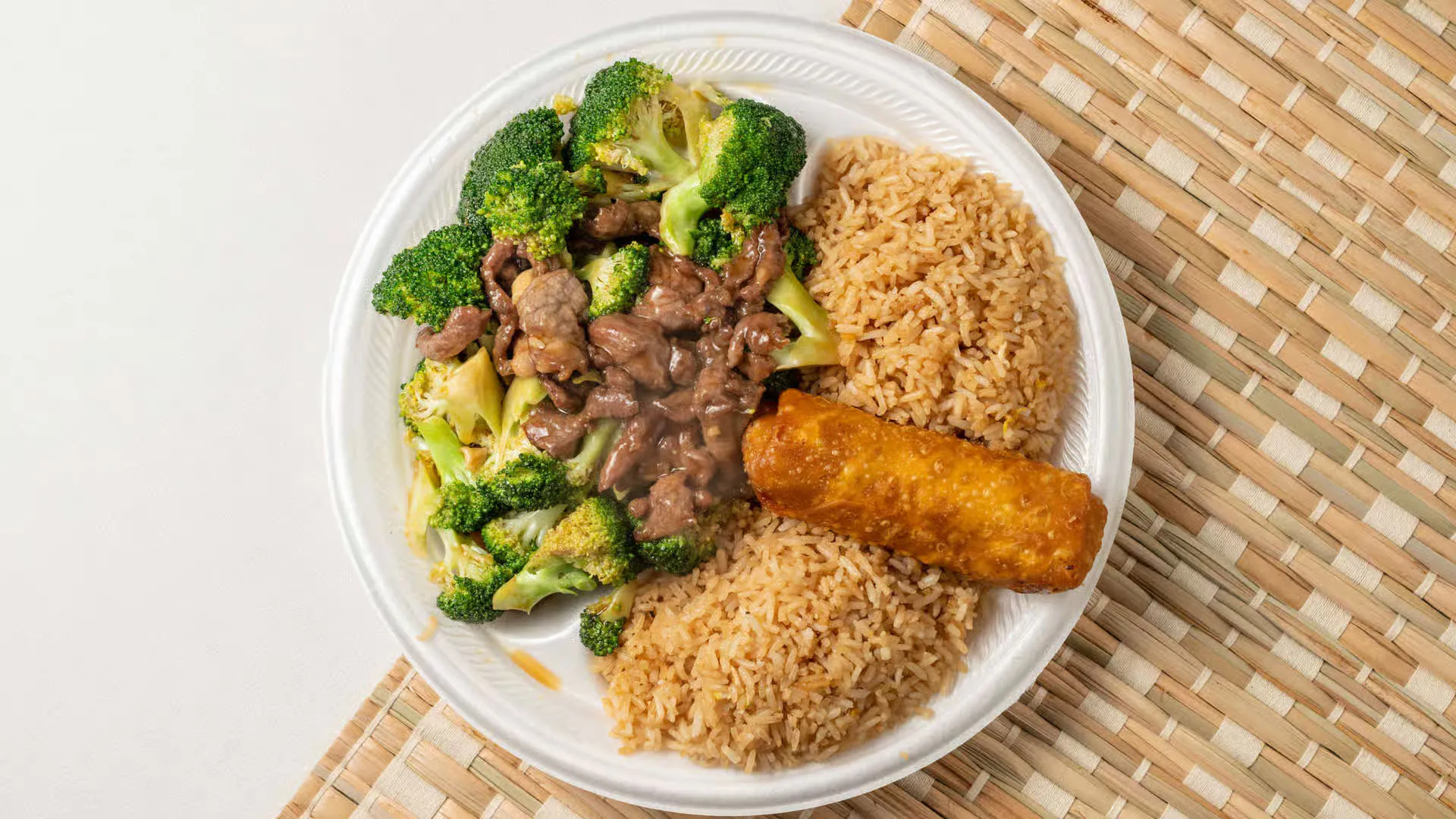 Savory beef & broccoli with fried rice and crispy egg roll at Fuji Asian Food Express, a Asian Restaurant in Greensboro